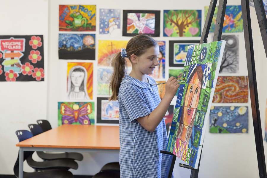 A Sydney Catholic school student paints a portrait in class