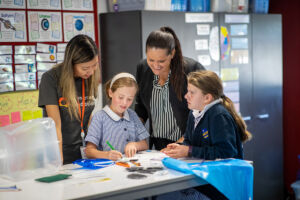 McAuley students make emergency water filters with Origin Foundation volunteers and principal Nicole Jones.