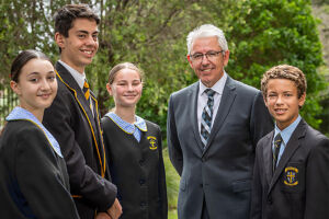 Champagnat - soon Corpus Christi College - principal Craig Mooney with students modelling the new uniforms.