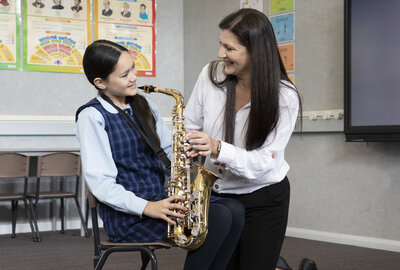 A Sydney Catholic Schools student receives a leeson as part of the systemwide Amadeus Music Education Program