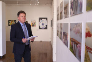 Sydney Catholic Schools' Executive Director, Tony Farley, goes over the choices while judging the 2022 Clancy Religious Art Prize