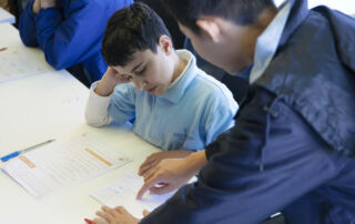 A Patrician Brothers' Fairfield maths student mentor helps a primary student solve a problem