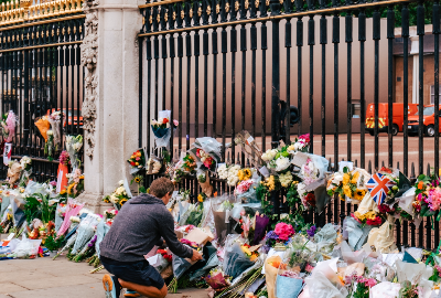 A mourner leaves flowers for Queen Elizabeth II