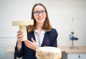 Domremy College Year 12 student Eva Kolokotsas with her HSC Design and Technology major project, a coffee table grown from mycelium.