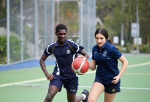 High school students play basketball at a Sydney Catholic school