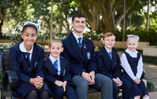 Photo of five students, both boys and girls, in their new St Mary's Cathedral College uniforms