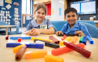 Primary school children work with blocks in a Mathematics lesson.