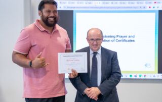 Family educator Richie Leilua receives a certificate from Sydney Catholic Schools' Director: Mission and Identity Anthony Cleary.