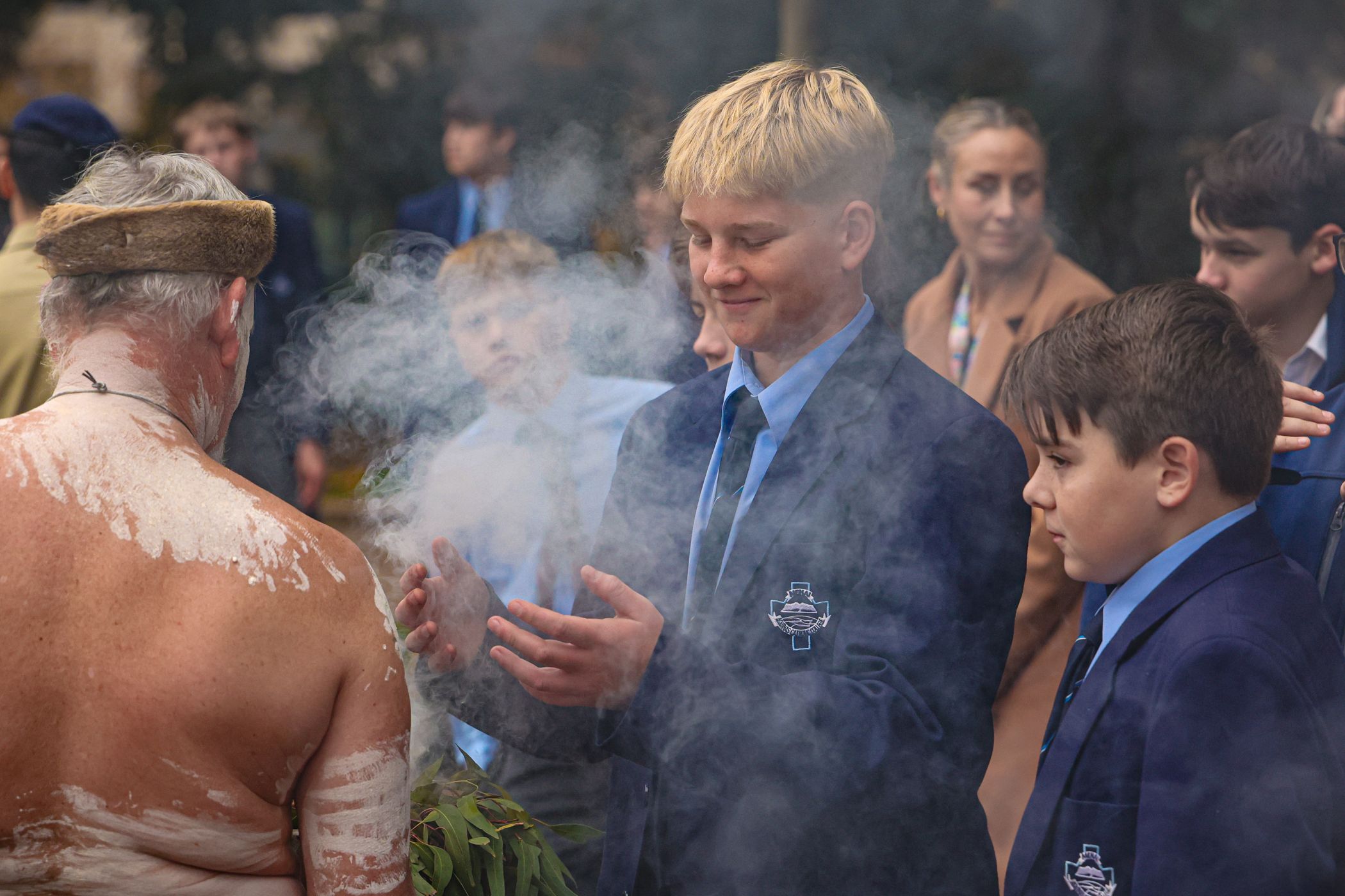 A student from Aquinas Catholic College Menai takes part in a traditional Aboriginal Smoking Ceremony