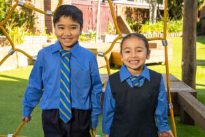 two students outside smiling