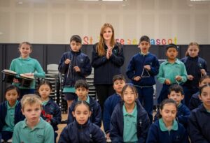 St Therese students with their musical instruments and classroom music teacher Meaghan Brady.