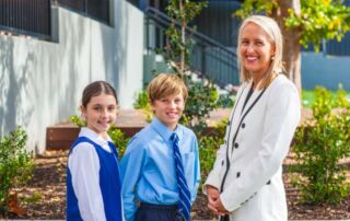 Image of Principal Diane Cowan with female and male students