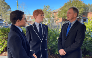 An image of Principal Peter Buxton speaking with two male students at De La Salle Catholic College Caringbah