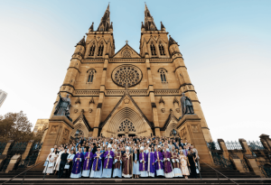 Photo showing beginning teachers, school leaders, and our new Executive Director, Danielle Cronin on the steps of St Mary's Cathedral