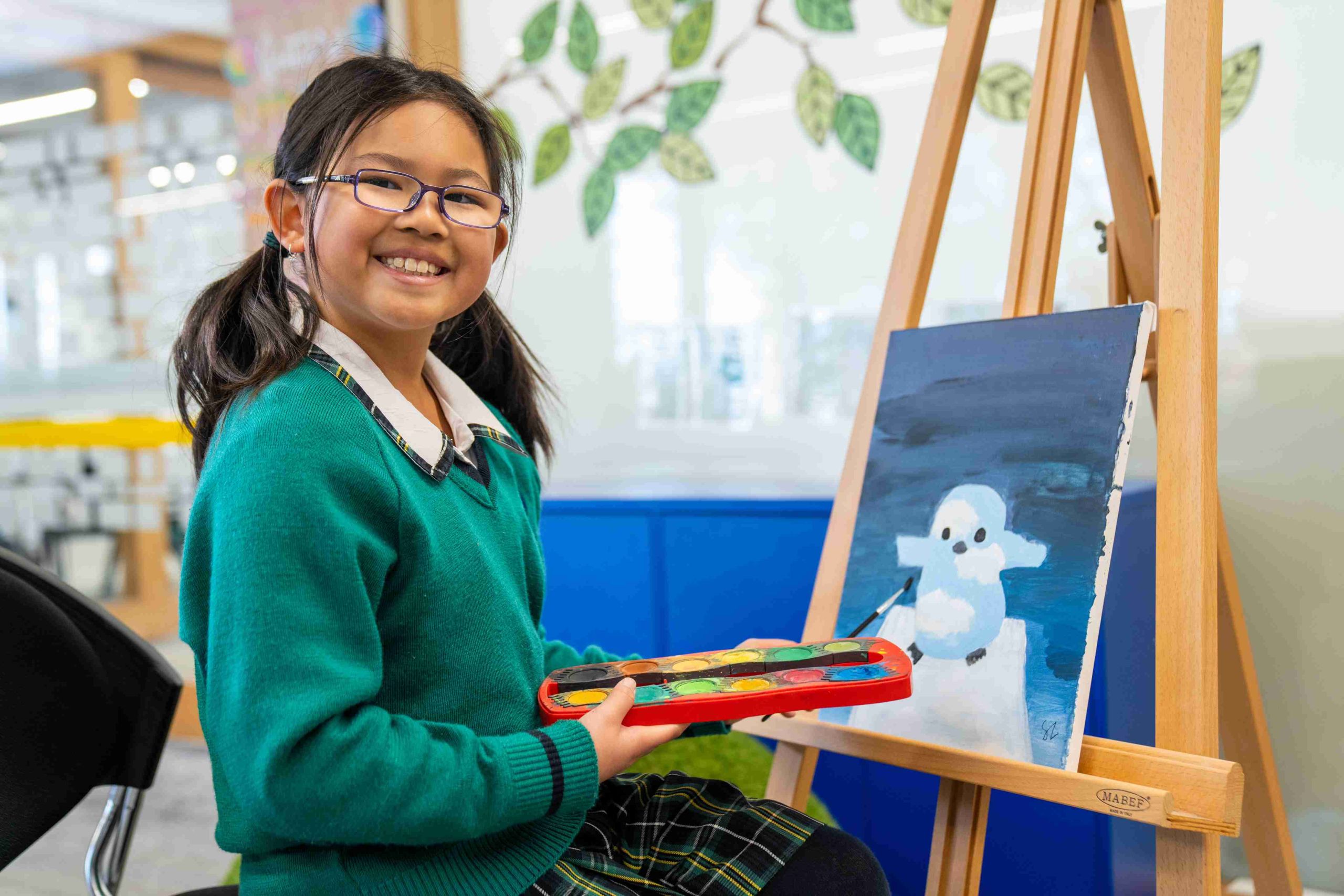A photo showing a student artist painting A photo showing a student artist painting