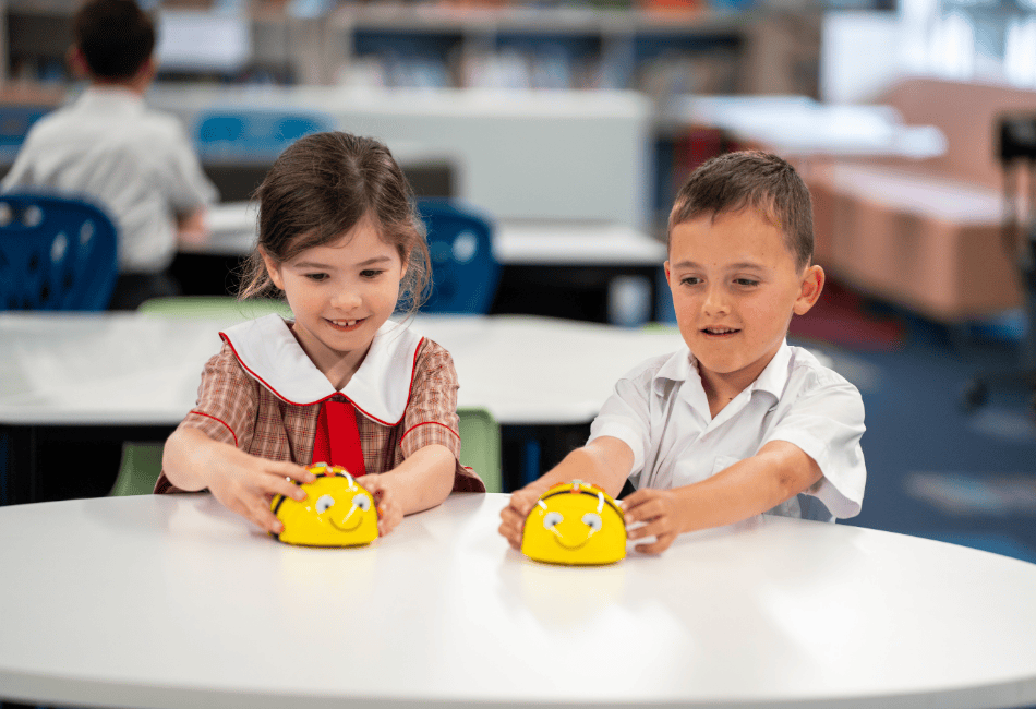 Photo showing two students learning with robotics through school STEM program