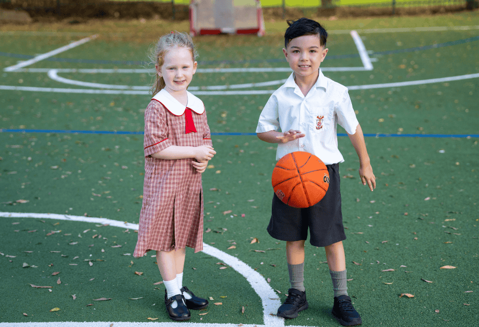 A photo showing two students playing in the school's spacious playground 
