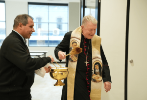 A photo of Bishop Brady blessing the Lumos Centre so that all who enter the space are also blessed