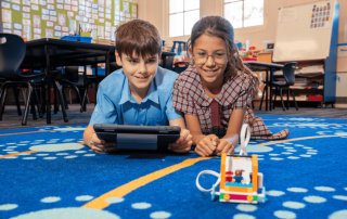 A photo showing two Sydney Catholic Schools students exploring STEM through coding and robotics.