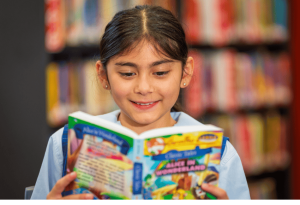 A photo of a student at St Anthony’s Catholic School Marsfield reading in the library