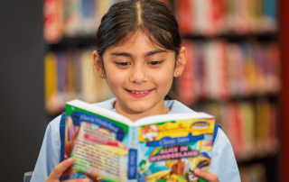 A photo of a student at St Anthony’s Catholic School Marsfield reading in the library