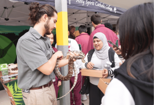A photo of Holy Spirit Lakemba students with a reptile exhibtor at the 2026 Careers Enrichment Day